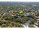 Aerial view showcasing the home nestled amongst lush landscaping, close to a lake at 3316 S Shamrock Rd, Tampa, FL 33629