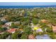 Aerial view of neighborhood showing a waterfront home surrounded by lush greenery and beautiful water views at 3316 S Shamrock Rd, Tampa, FL 33629