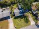 A sunny aerial view shows the home with a large, grassy backyard and mature landscaping at 3316 S Shamrock Rd, Tampa, FL 33629