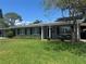 Charming single-story home with a well-manicured lawn, brick facade, and black shutters at 3316 S Shamrock Rd, Tampa, FL 33629