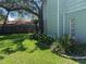 Side yard featuring flower beds and large shade tree at 3316 S Shamrock Rd, Tampa, FL 33629