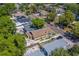 Aerial view of a residential property featuring mature trees, a fenced yard, and driveway at 3504 N 12Th St, Tampa, FL 33605