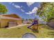 Backyard with playset, hot tub, patio seating, and trampoline, providing various outdoor activities at 3504 N 12Th St, Tampa, FL 33605