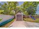 Spacious backyard featuring a shed, playset, lush greenery, and ample room for activities at 3504 N 12Th St, Tampa, FL 33605