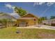 View of the home's backyard, showcasing a patio, green space, and mature trees at 3504 N 12Th St, Tampa, FL 33605
