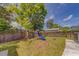 The backyard features mature trees and a playset for children to enjoy at 3504 N 12Th St, Tampa, FL 33605