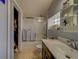 This bathroom features a tub with glass doors, updated vanity and neutral tones at 3504 N 12Th St, Tampa, FL 33605