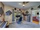 This music room features a piano, a cat tree, a desk with computers, a storage shelf, and two windows for natural light at 3504 N 12Th St, Tampa, FL 33605