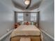 Bedroom with carpeted floors, large windows, ceiling fan and neutral gray walls at 3504 N 12Th St, Tampa, FL 33605
