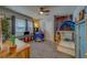 This is a carpeted bedroom with natural light, built in shelving, and a fun play tent at 3504 N 12Th St, Tampa, FL 33605