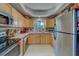 Efficient kitchen featuring a tile backsplash, stainless steel appliances, and light wood cabinets with ample storage at 3504 N 12Th St, Tampa, FL 33605