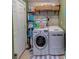 Well-organized laundry room equipped with modern washer and dryer units, shelving for storage, and a convenient folding area at 3504 N 12Th St, Tampa, FL 33605