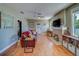 Comfortable living room featuring a decorative fireplace, hardwood floors, and lots of natural light at 3504 N 12Th St, Tampa, FL 33605