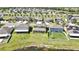 A neighborhood is shown with green landscaping and homes by a pond in an aerial shot at 35965 Saddle Palm Way, Zephyrhills, FL 33541