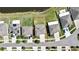Aerial shot shows a neighborhood home featuring a spacious green yard with a pond in the background at 35965 Saddle Palm Way, Zephyrhills, FL 33541