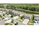 An aerial view showcases homes near a serene pond and lush green landscaping at 35965 Saddle Palm Way, Zephyrhills, FL 33541