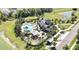 An aerial view showcases the community pool and playground with palm trees and sidewalks surrounding them at 35965 Saddle Palm Way, Zephyrhills, FL 33541