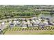 Aerial view of the home surrounded by lush greenery, a lake, and a well-maintained neighborhood at 35965 Saddle Palm Way, Zephyrhills, FL 33541