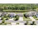 An aerial view showcases homes with a serene pond and green landscaping in a neighborhood at 35965 Saddle Palm Way, Zephyrhills, FL 33541