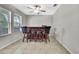 Bar room featuring a dark wood bar, three stools, tile flooring, and a cozy, intimate setting at 35965 Saddle Palm Way, Zephyrhills, FL 33541
