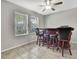Cozy bar area features tile flooring, a ceiling fan, and a classic wood bar with comfortable seating at 35965 Saddle Palm Way, Zephyrhills, FL 33541