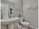 Charming half-bathroom featuring white fixtures, decorative wall art, and stylish accents at 35965 Saddle Palm Way, Zephyrhills, FL 33541