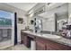 Well-lit bathroom with double vanity, granite countertop, and decorative accents create a spa-like atmosphere at 35965 Saddle Palm Way, Zephyrhills, FL 33541