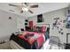 Cozy bedroom features gray walls, a ceiling fan, and a comfortable bed, creating a restful atmosphere at 35965 Saddle Palm Way, Zephyrhills, FL 33541