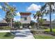 Community clubhouse entrance with a manicured lawn, palm trees, and a walkway, shows curb appeal at 35965 Saddle Palm Way, Zephyrhills, FL 33541