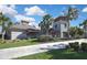 Exterior view of the clubhouse and manicured landscaping creates an inviting and appealing community atmosphere at 35965 Saddle Palm Way, Zephyrhills, FL 33541