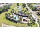 Aerial view of a community pool and recreational area surrounded by lush landscaping and palm trees, offering a resort-style amenity at 35965 Saddle Palm Way, Zephyrhills, FL 33541