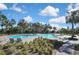 Community pool with inviting lounge chairs and surrounded by verdant landscaping providing an ideal space for relaxation at 35965 Saddle Palm Way, Zephyrhills, FL 33541