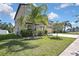 Two-story home with a three-car garage, stucco exterior, lawn, and well-maintained landscaping at 35965 Saddle Palm Way, Zephyrhills, FL 33541