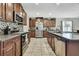 Spacious kitchen featuring stainless steel appliances, granite countertops, and ample cabinet space at 35965 Saddle Palm Way, Zephyrhills, FL 33541