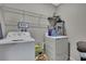 Functional laundry area with washer, dryer, and shelving for storage at 35965 Saddle Palm Way, Zephyrhills, FL 33541