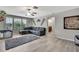 Bright living room with a cozy sectional couch, and contemporary decor, ideal for relaxation and entertainment at 35965 Saddle Palm Way, Zephyrhills, FL 33541