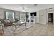 Bright living space with a shiplap fireplace, TV and views of the backyard at 35965 Saddle Palm Way, Zephyrhills, FL 33541