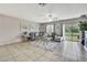 Bright living area with tile flooring, comfortable seating, and sliding glass doors to the backyard at 35965 Saddle Palm Way, Zephyrhills, FL 33541