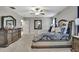Spacious primary bedroom with ceiling fan, carpet flooring, and access to ensuite bathroom at 35965 Saddle Palm Way, Zephyrhills, FL 33541