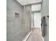 Modern bathroom featuring glass walk-in shower, gray tiling, and a built-in shower niche at 4319 Harbor House Dr, Tampa, FL 33615