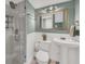 Bathroom featuring a glass door shower, tile floors, toilet, and a decorative mirror at 4319 Harbor House Dr, Tampa, FL 33615