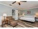 Relaxing bedroom with a large bed, a comfortable armchair, and a window for natural light at 4319 Harbor House Dr, Tampa, FL 33615