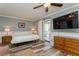 Comfortable bedroom featuring a ceiling fan, a large bed, a wooden dresser, and outdoor access at 4319 Harbor House Dr, Tampa, FL 33615