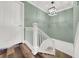 Well-lit hallway featuring white trim and decorative molding, connecting rooms and stairway to lower level at 4319 Harbor House Dr, Tampa, FL 33615