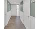 A hallway with neutral paint, tiled floors, and white trim provides a clean and inviting transition space at 4319 Harbor House Dr, Tampa, FL 33615