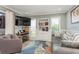 Comfortable living room with a large built-in shelf, television, and an accent rug on tile flooring at 4319 Harbor House Dr, Tampa, FL 33615