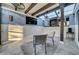Cozy screened patio with ceiling fan, TV, and stylish outdoor seating and star fish patterned rug at 4319 Harbor House Dr, Tampa, FL 33615