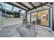 Inviting screened patio with ceiling fan, TV, and stylish outdoor seating, with view to kitchen at 4319 Harbor House Dr, Tampa, FL 33615