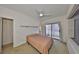 Bright bedroom with sliding glass doors to patio, and ceiling fan at 4405 W Fair Oaks Ave # 9, Tampa, FL 33611