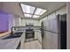 Bright kitchen features stainless steel appliances and a large skylight at 4405 W Fair Oaks Ave # 9, Tampa, FL 33611